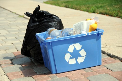 Workers wearing PPE handling commercial waste containers